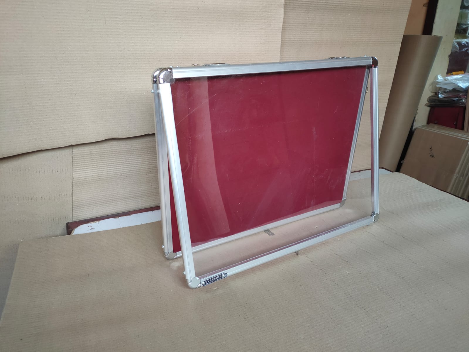 Evershine enclosed notice board with doors mounted in a building corridor